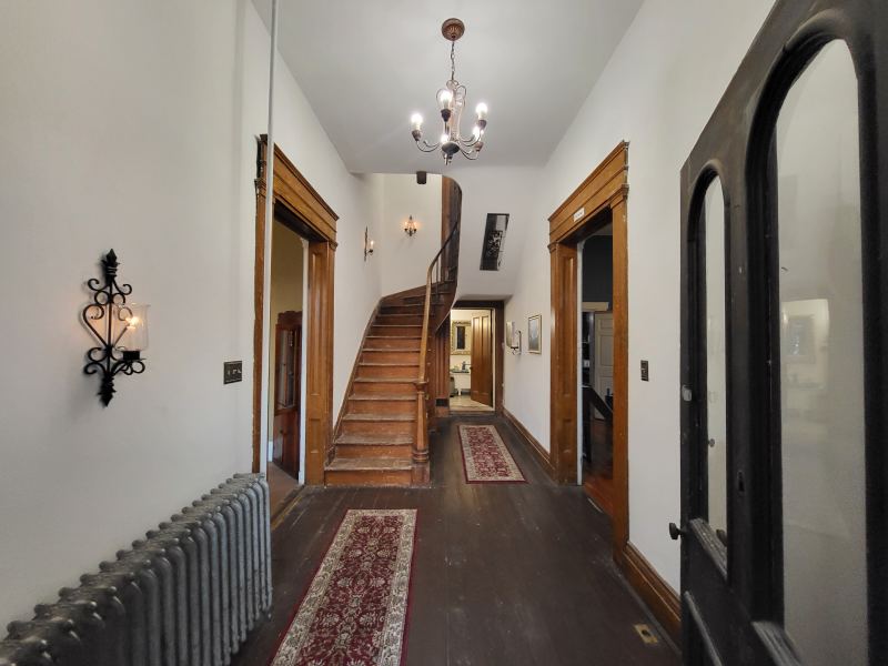 Original listing photo of the Champion House entry hall and staircase
