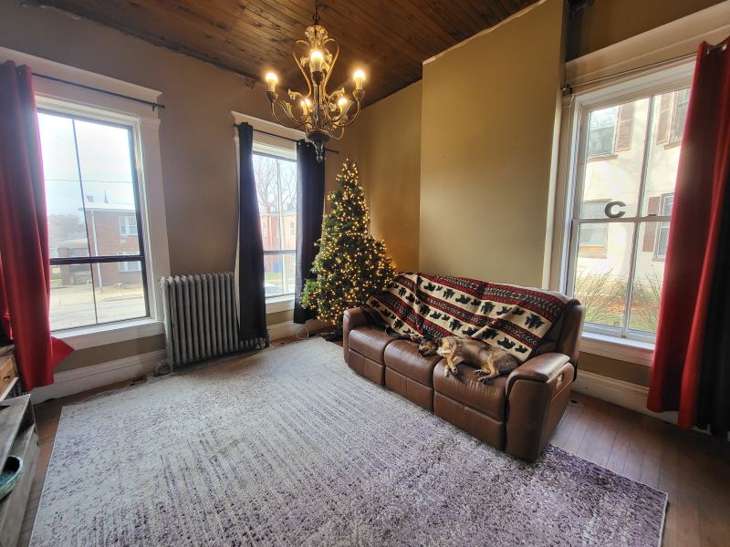 Original listing photo of a Champion House sitting room with holiday tree