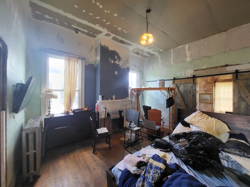 Original listing photo of a Champion House bedroom under restoration
