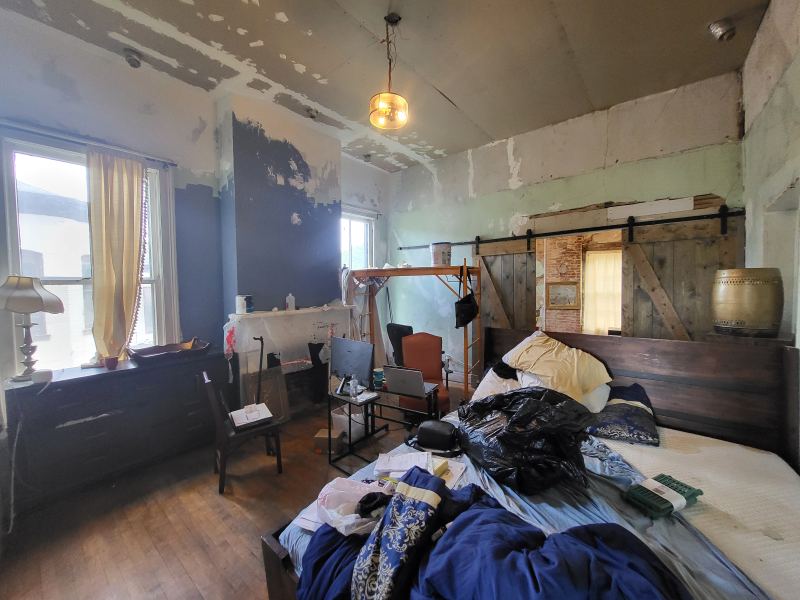 Original listing photo of a Champion House bedroom fireplace wall