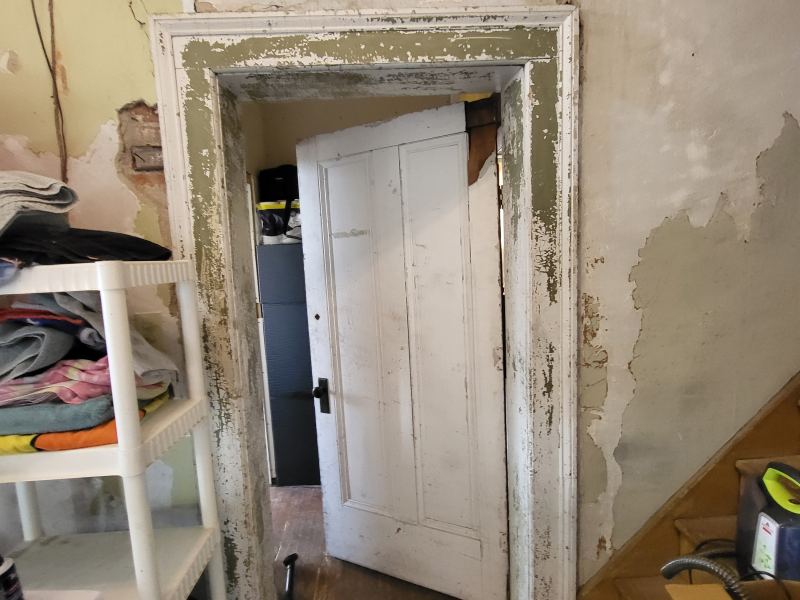 Original listing photo of a Champion House doorway with worn plaster
