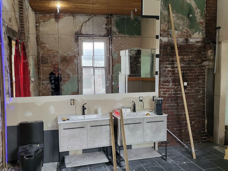 Original listing photo of Champion House bath sinks and tile floor