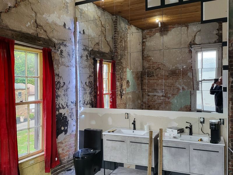 Original listing photo of Champion House bath sinks and red curtains