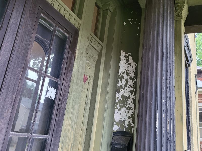 Original listing photo of Champion House porch column and window trim