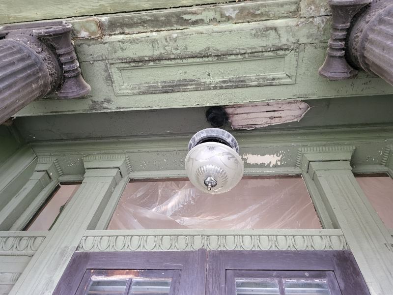 Original listing photo of Champion House porch ceiling light and brackets