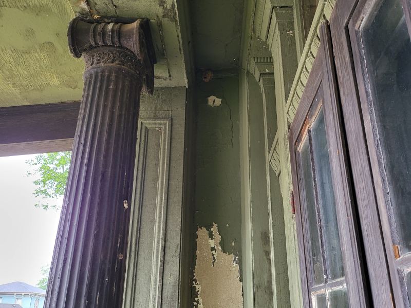 Original listing photo of Champion House porch column and light fixture